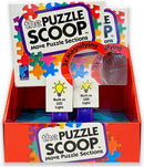 The Puzzle Scoop by CEACO is a colorful jigsaw puzzle tool featuring a vibrant box design with puzzle piece motifs. It includes a 3x magnifying feature and built-in LED lights to illuminate puzzle sections, enhancing the puzzle assembling experience. Perfect for puzzle lovers looking for convenience and clarity while working on their favorite jigsaw puzzles.