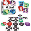 Yokai - Memory Game by Gamewright. The game features a colorful box depicting various Japanese yokai characters, with cards laid out in a grid format showcasing unique illustrations of the characters. This memory game encourages players to match identical pairs while exploring a spirited theme.