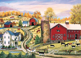 A vibrant jigsaw puzzle titled 'Leading the Way' by Cobble Hill, depicting a picturesque farm scene. The illustration features a red barn, white farmhouse, horses grazing, cows in a pasture, and lush fall foliage under a colorful sky. A serene dirt road winds through the landscape, adding to the tranquil rural charm.