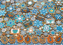 A colorful collection of Hanukkah-themed cookies arranged like a jigsaw puzzle. The cookies feature intricate designs including stars, menorahs, dreidels, and snowflakes in blue, white, and gold. Each cookie shape celebrates Hanukkah with festive symbols, creating a visually appealing holiday treat.