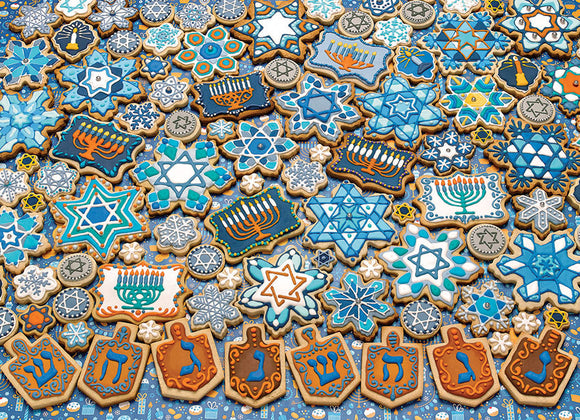 A colorful collection of Hanukkah-themed cookies arranged like a jigsaw puzzle. The cookies feature intricate designs including stars, menorahs, dreidels, and snowflakes in blue, white, and gold. Each cookie shape celebrates Hanukkah with festive symbols, creating a visually appealing holiday treat.