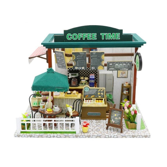 A detailed miniature DIY kit featuring a coffee shop scene titled ‘Coffee Time’. It shows outdoor seating with a green umbrella, a menu board, and various decorative elements like flowers and coffee-making equipment. The kit allows enthusiasts to assemble their own charming coffee shop model.
