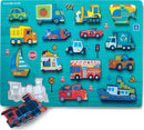 Let's Play Wood Puzzle by Crocodile Creek featuring colorful jigsaw pieces shaped like various vehicles including cars, trucks, a train, a helicopter, and a sailboat, set on a blue background with road signs, making it an engaging toy for toddlers.