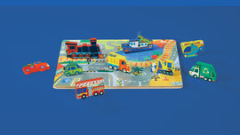 Let's Play Wood Puzzle featuring colorful vehicle-shaped pieces including a train, boat, helicopter, and various trucks, set on a vibrant road and landscape background. Ideal for children's play and learning.