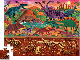 A vibrant 48-piece jigsaw puzzle titled 'Dinosaur World' by Crocodile Creek. The puzzle features an assortment of dinosaurs like T. rex, Stegosaurus, and Brontosaurus set against a colorful prehistoric landscape with lush vegetation and a sunset sky. The bottom section reveals dinosaur fossils in a sandy excavation scene, adding an educational element to the fun.