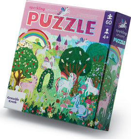 A colorful jigsaw puzzle box featuring a vibrant illustration of unicorns in a magical landscape with rainbows, trees, and flowers. The puzzle contains 60 pieces and is suitable for children aged 4 and up. The title 'Sparkling Unicorn Puzzle' is prominently displayed on the box.