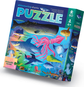 Shimmering Sharks Foil Puzzle box featuring vibrant ocean life including various sharks, an octopus, and a whale, with the title prominently displayed. Ideal for kids aged 4 and up.