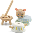 The BabySouri toy by DJECO features a whimsical, tiger-themed design with colorful components. It includes a round head with expressive eyes and ears, two wooden bases in pastel colors, and a spinning stick. These pieces are made from high-quality wood, promoting sensory play and fine motor skill development for toddlers.