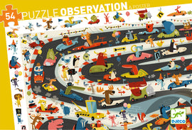 Observation: Automobile Rally jigsaw puzzle featuring a colorful illustration of various animals racing in cars. The scene is filled with vibrant characters like a bear, a moose, a crocodile, and a lion driving quirky vehicles around a winding racetrack, along with balloons and flags to create a festive atmosphere.