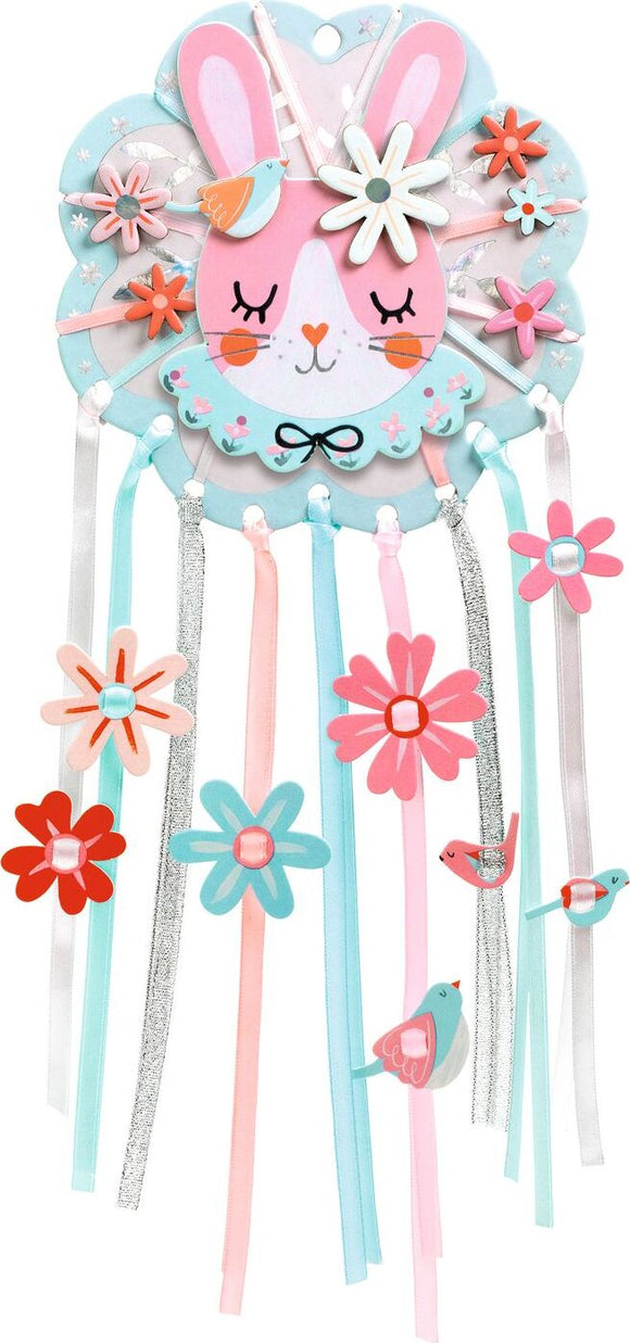 Colorful DIY kit featuring Dreamer Dreamcatcher by DJECO. The kit showcases a playful design with a pink bunny face adorned with flowers, ribbons, and birds intricately hanging below, encouraging creativity and imagination.