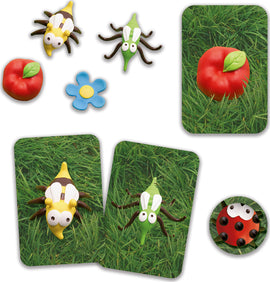 The Mosquito Family Game by DJECO features colorful, insect-themed game pieces including a yellow bug, a green bug, a red apple, and a blue flower, set against a grassy background. The game is designed for engaging family fun and interactive play, fostering cognitive skills through matching and memory exercises.