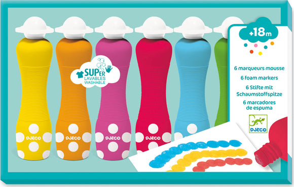 Six colorful foam paint spot markers in yellow, orange, pink, red, blue, and green, each with a white polka dot design. The markers are washable and designed for creative activities. A white sheet shows painted dots in blue, yellow, and red.