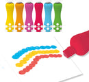 Set of six foam paint spot markers by DJECO, featuring vibrant colors including yellow, orange, pink, blue, green, and red. The markers have a unique ergonomic design for easy grip and application, with a smooth tip for creating bold dots and patterns. They are showcased next to a white sheet of paper, which displays colorful dotted lines in blue, yellow, and red, demonstrating their artistic potential.