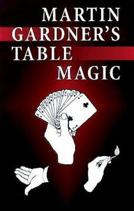 Cover of Martin Gardner's Table Magic, featuring an image of hands displaying a fan of playing cards and performing a magic trick with a lit match. The background is predominantly black with red accents, highlighting the title in bold white letters.
