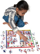 A child concentrating on assembling the 100-piece 'Children of the World' jigsaw puzzle by Eeboo. The puzzle features colorful illustrations of children from various cultures, with several pieces scattered around her. The child wears a striped shirt and blue polka dot pants and is kneeling on the floor, focused on fitting a puzzle piece into place.