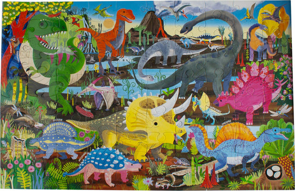 A colorful jigsaw puzzle titled 'Land of the Dinosaurs' by Eeboo. It features various cartoon dinosaurs such as a Tyrannosaurus Rex, Triceratops, and Stegosaurus in a vibrant prehistoric landscape filled with plants, trees, and a volcanic background. The puzzle is made up of interlocking pieces, showcasing intricate details and diverse dinosaur species.