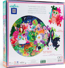The Garden Sanctuary jigsaw puzzle by Eeboo features a vibrant round design filled with colorful illustrations of animals and flowers, showcasing a whimsical natural scene. The image highlights a peacock, monkeys, rabbits, and more surrounded by lush greenery and floral elements. The puzzle has a 23-inch diameter and is presented in a beautifully illustrated box.