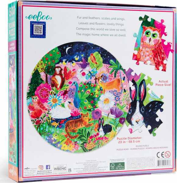 The Garden Sanctuary jigsaw puzzle by Eeboo features a vibrant round design filled with colorful illustrations of animals and flowers, showcasing a whimsical natural scene. The image highlights a peacock, monkeys, rabbits, and more surrounded by lush greenery and floral elements. The puzzle has a 23-inch diameter and is presented in a beautifully illustrated box.
