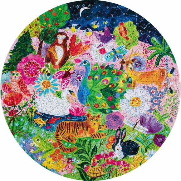 A colorful round jigsaw puzzle titled 'Garden Sanctuary' by Eeboo, featuring vibrant illustrations of various animals such as a tiger, peacock, and rabbit surrounded by lush flowers and greenery set against a night sky.