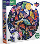 The Eeboo 'Pebbles' Jigsaw Puzzle features a vibrant, round 500-piece design showcasing a stunning array of colorful moths and flowers against a dark blue background. The puzzle pieces are intricately cut, creating a captivating image that combines nature's beauty with the challenge of puzzling. Ideal for both children and adults, this eco-friendly puzzle promises hours of engaging entertainment and relaxation.