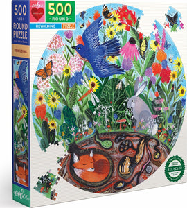 The Rewilding Round Puzzle by Eeboo features a vibrant design showcasing a variety of animals including a bluebird, rabbit, and fox among colorful flowers and lush greenery. It comprises 500 pieces in a circular format, promoting a connection to nature and wildlife. The packaging highlights the use of recycled materials and is suitable for both adults and children for a delightful family activity.
