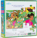 The Eeboo 'Out to Play' jigsaw puzzle features a vibrant illustration of children playing outdoors in a lush garden setting. The colorful design showcases kids enjoying various activities like swinging, playing with a ball, and interacting with animals. The puzzle contains 64 pieces and is perfect for promoting creativity and problem-solving skills. The packaging highlights the puzzle size of 15 x 15 inches and emphasizes that the image on the box is an actual piece size.
