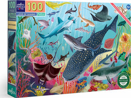 The 'Love of Sharks' jigsaw puzzle by Eeboo features an array of vibrant marine life, including various species of sharks, colorful coral reefs, and other ocean inhabitants. This 100-piece puzzle comes with an informational poster and is suitable for ages 5 and up. The artwork showcases detailed illustrations in bright colors, perfect for ocean enthusiasts and puzzle lovers alike.