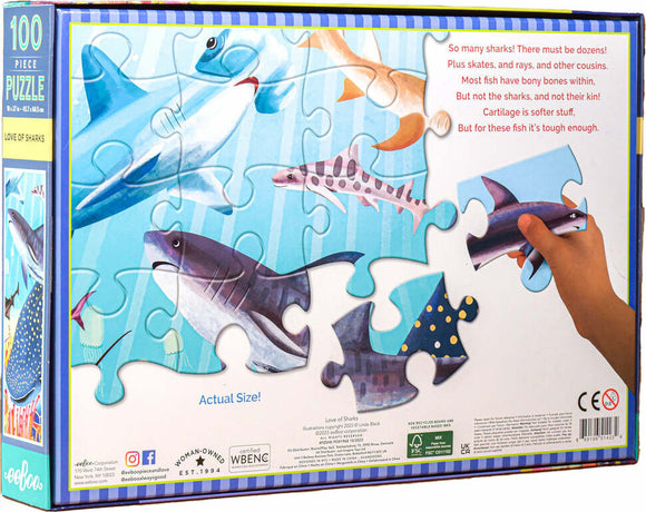 The 'Love of Sharks' jigsaw puzzle by Eeboo features a colorful illustration of various species of sharks swimming in a vibrant underwater scene. The packaging showcases a hand holding a puzzle piece, demonstrating the playful and educational theme. The puzzle consists of 100 pieces, ideal for children and adults alike who are fascinated by marine life.