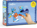 Eeboo Sea Exploration 20-piece jigsaw puzzle featuring vibrant, colorful marine life illustrations. The box displays a hand holding an actual puzzle piece, emphasizing the large size of the pieces. The puzzle measures 11 x 15 inches, suitable for kids and families. Ideal for promoting cognitive skills and creativity through play.