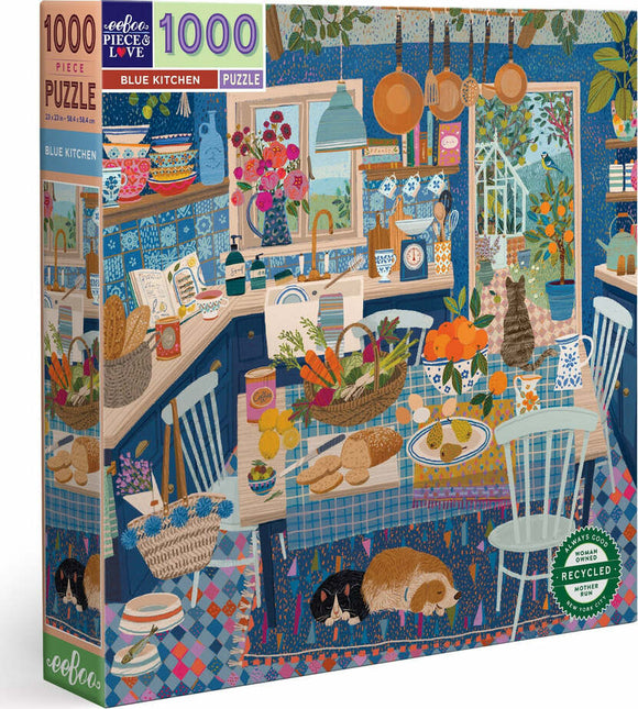 Eeboo's Blue Kitchen jigsaw puzzle featuring a vibrant kitchen scene. The puzzle depicts a cozy kitchen with a blue color scheme, filled with various cookware, fruits, and two sleeping dogs on a colorful rug. The intricate details showcase baskets of vegetables, cookbooks, and hanging utensils, making it a delightful and engaging puzzle for all ages.