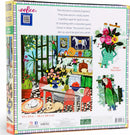 Eeboo Green Kitchen jigsaw puzzle featuring a vibrant kitchen scene filled with colorful flowers, fruits, and playful animals, designed in a blend of greens. The puzzle depicts a cozy atmosphere with decorative items and a cheerful parrot, making it perfect for relaxation and family fun. The box dimensions are 23 x 23 inches.