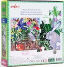Eeboo Wild Things jigsaw puzzle featuring a vibrant illustration of a lush garden filled with colorful flowers, butterflies, birds, and playful animals like rabbits and foxes. The puzzle contains 64 pieces and measures 15x15 inches. The box highlights phrases about the beauty of untamed nature.