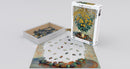 Eurographics 1000-piece jigsaw puzzle featuring a beautiful painting of Jerusalem Artichoke Flowers by Claude Monet. The box shows the completed artwork, while the puzzle pieces are partially assembled on a flat surface, showcasing vibrant colors and intricate details.