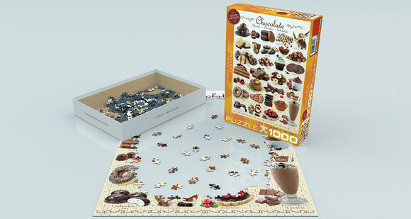 Eurographics Chocolate jigsaw puzzle featuring an assortment of delectable chocolate desserts. The puzzle box is displayed alongside partially completed puzzle pieces spread across a light surface. The puzzle has 1000 pieces and includes various sweet treats like cupcakes, pralines, and brownies, perfect for puzzle enthusiasts and chocolate lovers alike.