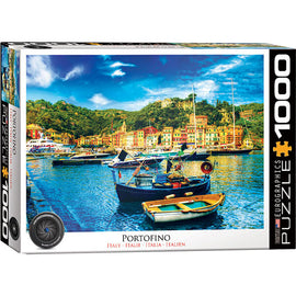 Eurographics jigsaw puzzle featuring a picturesque view of Portofino, Italy. The 1000-piece puzzle showcases colorful boats and vibrant waterfront buildings surrounded by lush hills, capturing the charm of the Italian Riviera.