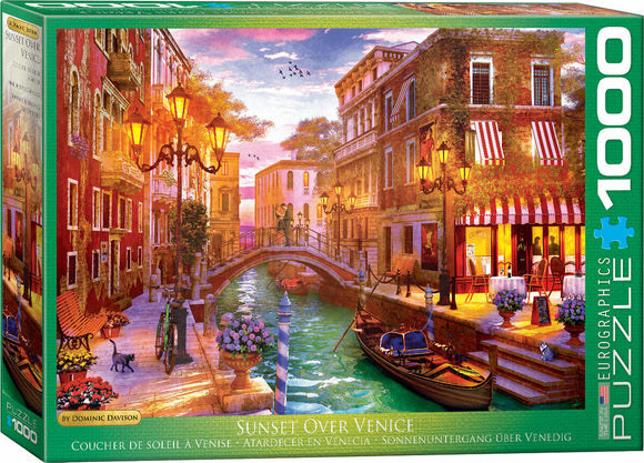A vibrant jigsaw puzzle box featuring a picturesque sunset scene over Venice. The artwork, created by Dominic Davison, showcases charming canals, quaint buildings adorned with flowers, and glowing street lamps. Ideal for puzzle lovers, it has 1000 pieces and invites you to explore the beauty of Venice.