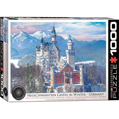 Eurographics jigsaw puzzle featuring Neuschwanstein Castle surrounded by snow-covered mountains in winter. The box displays a beautifully detailed image of the iconic castle, showcasing its towers and turrets amidst a serene winter landscape.