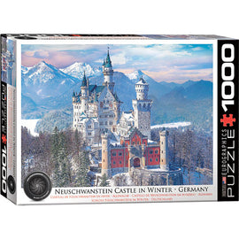 Eurographics jigsaw puzzle featuring Neuschwanstein Castle surrounded by snow-covered mountains in winter. The box displays a beautifully detailed image of the iconic castle, showcasing its towers and turrets amidst a serene winter landscape.