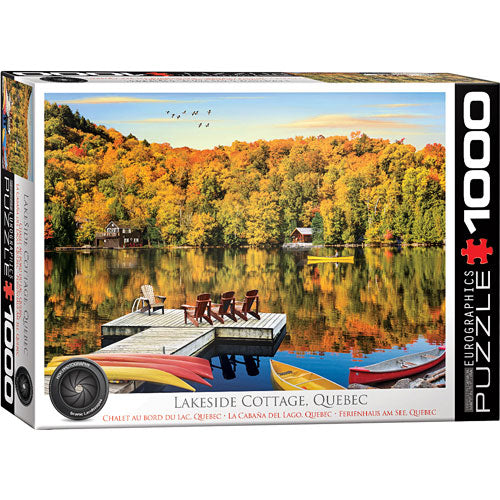 Eurographics jigsaw puzzle featuring a serene lakeside cottage setting in Quebec. The image showcases vibrant fall foliage reflecting in calm waters, with a wooden dock and colorful kayaks in the foreground, creating a peaceful and picturesque outdoor scene.