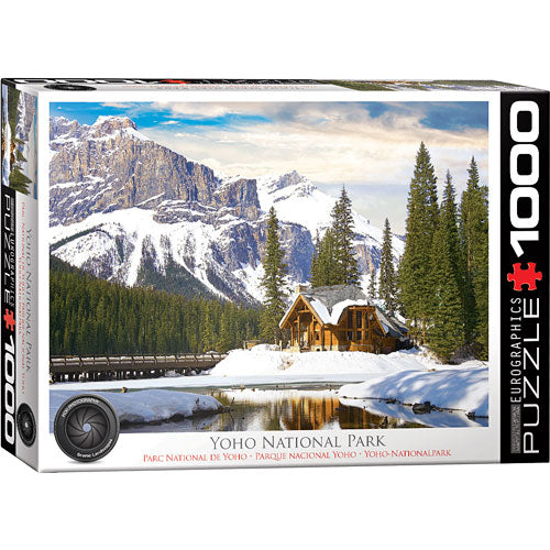 A beautifully designed jigsaw puzzle box featuring a scenic view of Yoho National Park in British Columbia. The image shows majestic mountains, a serene lake, and a cozy cabin surrounded by lush evergreen trees, set against a picturesque snowy landscape. The box is labeled 'Yoho National Park' and includes the Eurographics logo, indicating the puzzle has 1000 pieces.