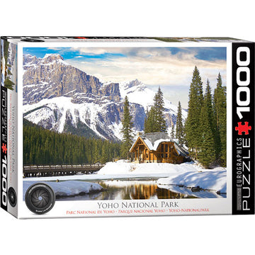 A beautifully designed jigsaw puzzle box featuring a scenic view of Yoho National Park in British Columbia. The image shows majestic mountains, a serene lake, and a cozy cabin surrounded by lush evergreen trees, set against a picturesque snowy landscape. The box is labeled 'Yoho National Park' and includes the Eurographics logo, indicating the puzzle has 1000 pieces.