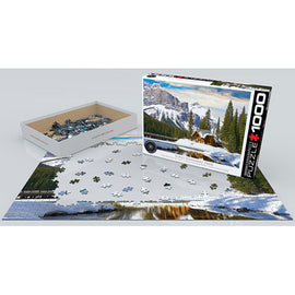 A 1000-piece jigsaw puzzle titled 'Yoho National Park British Columbia' by Eurographics, featuring a scenic landscape with mountains, a lake, and trees. The box is partially opened, revealing colorful puzzle pieces arranged next to the layout of the partially completed puzzle on a flat surface.