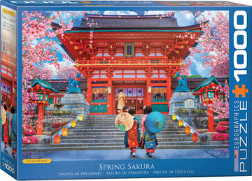 The Spring Sakura jigsaw puzzle by Eurographics features a stunning illustration of traditional Japanese architecture surrounded by blooming cherry blossom trees. The vibrant image depicts elegantly dressed figures with colorful umbrellas walking up staircases illuminated by lanterns, capturing the essence of spring in Japan. This 1000-piece puzzle provides a challenging and engaging experience for puzzle enthusiasts.