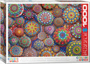 A vibrant jigsaw puzzle box featuring the Meditative Mandala Stones design. The image showcases colorful, intricately patterned stones in various sizes and shapes, enhancing the serene and artistic appeal of the puzzle. The box includes the Eurographics logo and indicates it contains 1000 pieces, promising a challenging yet rewarding puzzle experience.