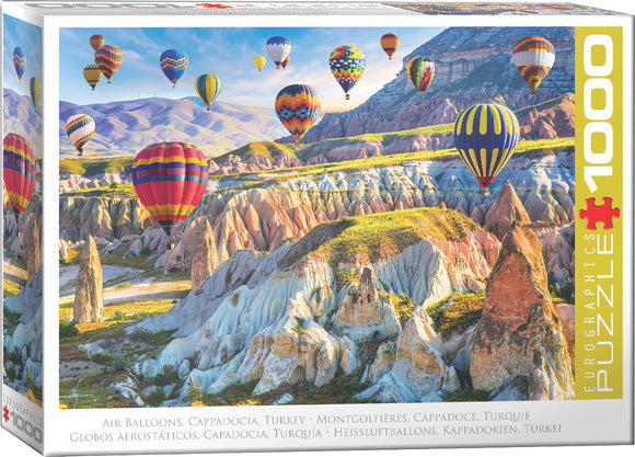 Air Balloons Over Cappadocia jigsaw puzzle by Eurographics features a stunning landscape of colorful hot air balloons soaring over the unique rock formations and valleys of Cappadocia, Turkey. The vibrant balloons add a splash of color against the serene backdrop of soft hills and blue skies, making it a captivating visual experience for puzzle enthusiasts.