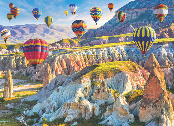 A vibrant jigsaw puzzle featuring colorful hot air balloons floating over the stunning landscape of Cappadocia. The scene captures unique rock formations and vivid colors against a clear blue sky, showcasing the enchanting beauty of this popular travel destination.