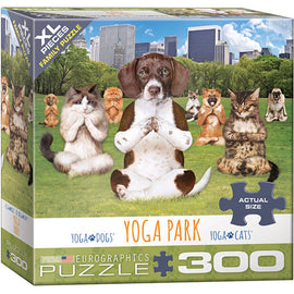 Eurographics Yoga Park jigsaw puzzle box featuring a whimsical scene with yoga-practicing dogs and cats in a park setting with city skyscrapers in the background. The puzzle includes 300 large pieces suitable for families and friends.