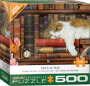 The Cat Nap jigsaw puzzle by Eurographics, featuring a cozy scene of a sleeping cat on a stack of vintage books, surrounded by flowers and an antique clock. Ideal for family fun with large pieces for easy handling.