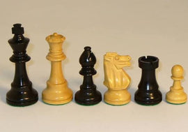 A collection of 3.75 inch black and natural boxwood chessmen arranged in a row. The set includes various chess pieces like a king, queen, rook, knight, and pawn, showcasing the elegant design and smooth finish typical of high-quality chess pieces. The contrasting black and natural wood colors enhance the visual appeal, making this chess set suitable for both play and display.