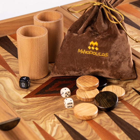 19-inch Olive Burl Backgammon Set by Manopoulos, featuring two wooden cups for rolling dice, a velvet pouch with an embroidered logo, and various playing pieces including dice and checkers, all elegantly displayed on a beautifully patterned game board.